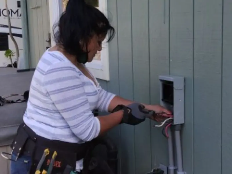 Licensed electrician wiring an exterior subpanel in Johnston